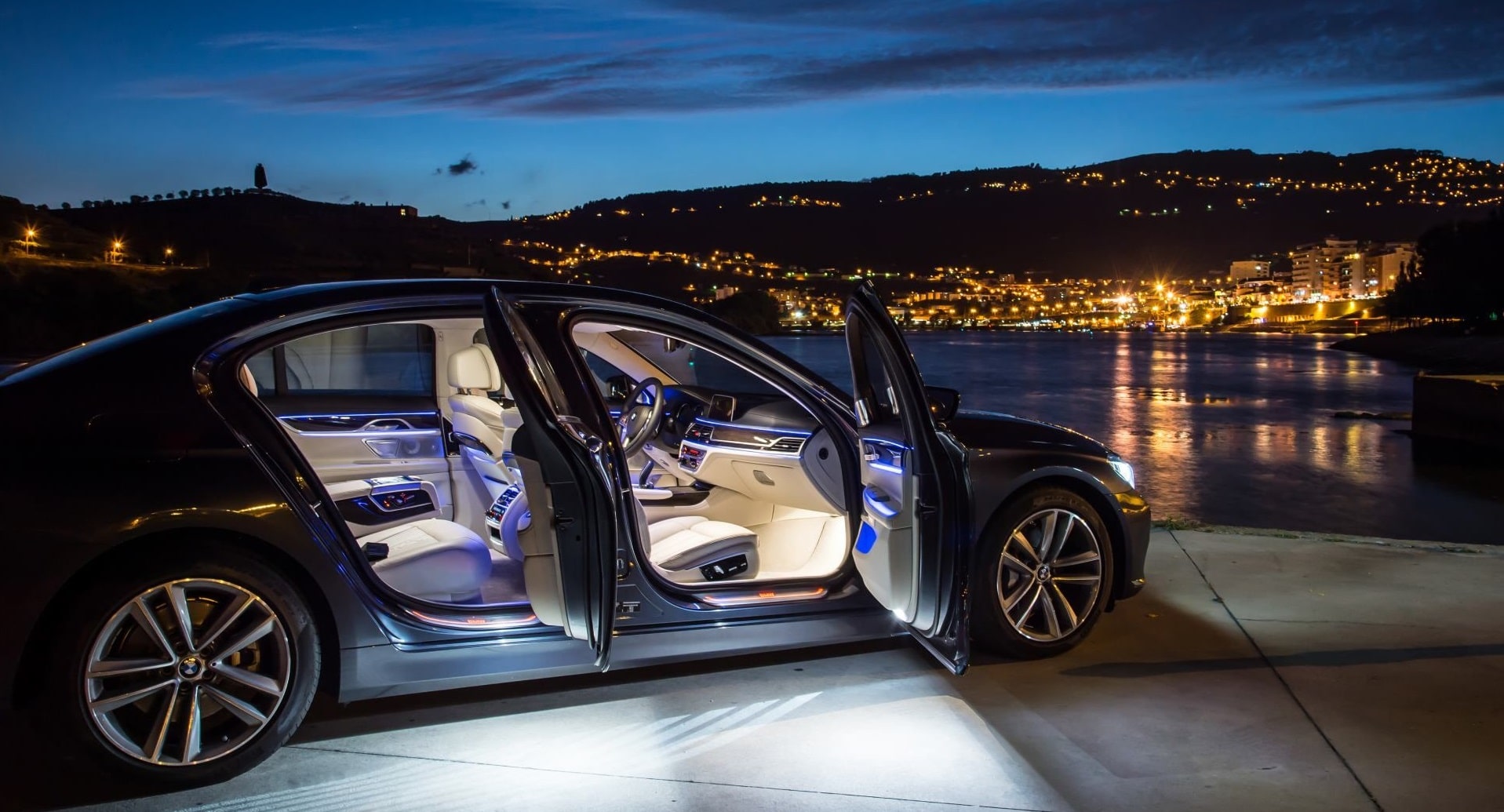 Luxury car stunning image of fully light interior against city skyline at dusk